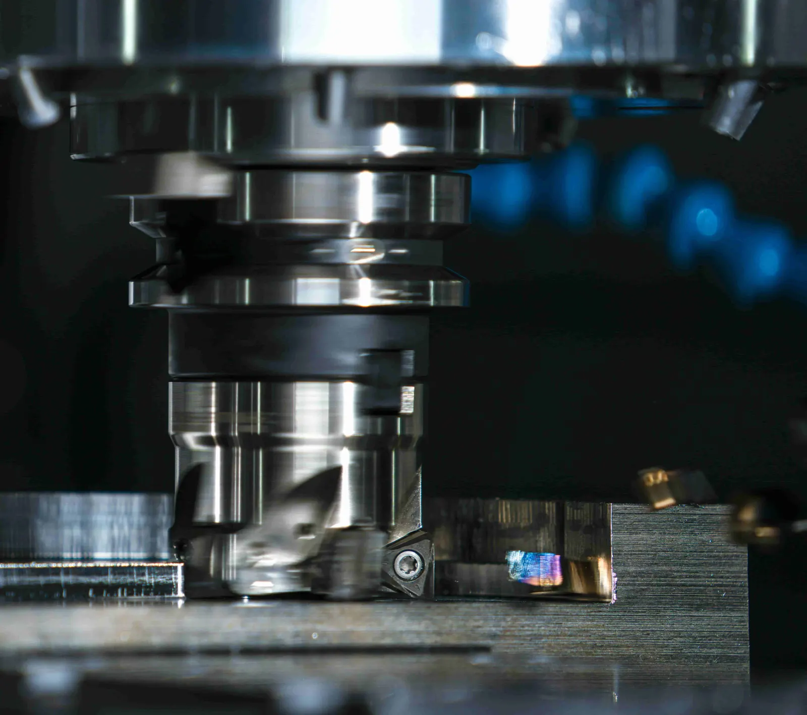 4-axis CNC milling center machining a precision metal component with multi-face access
